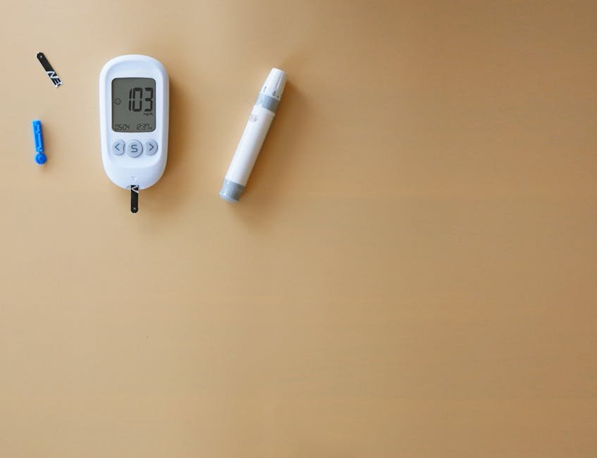 Blood glucose meter and lancet pen on wood for diabetes monitoring