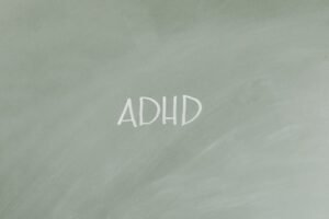 Simple illustration highlighting ADHD awareness with text on a gray background.