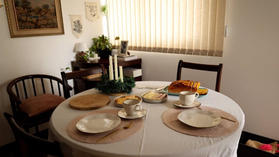 A well-arranged breakfast table with bread, coffee, and cutlery in a cozy dining room setting.