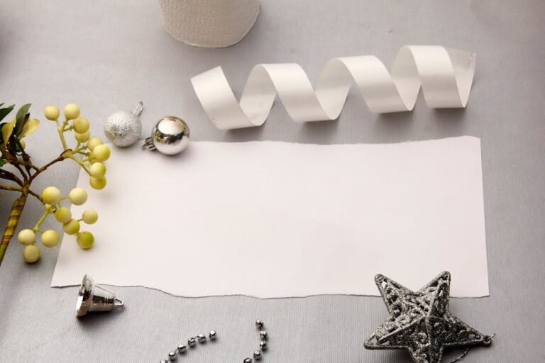 A festive flat lay featuring Christmas decorations and a blank paper for copyspace.