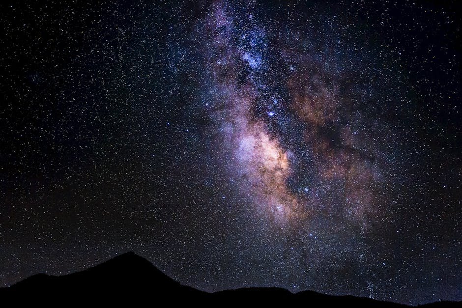 Captivating night sky featuring the Milky Way above silhouetted mountains in Onyx, California.