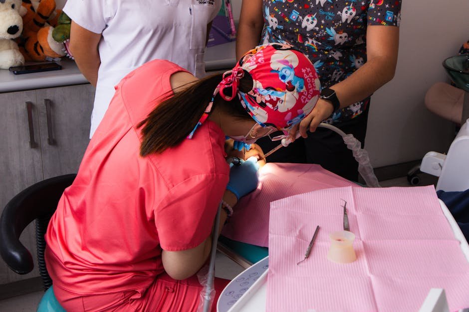 A pediatric dentist provides dental care to a child with professional equipment.