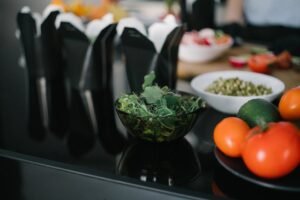 Close-up of fresh vegetables and takeout containers in a kitchen setting.