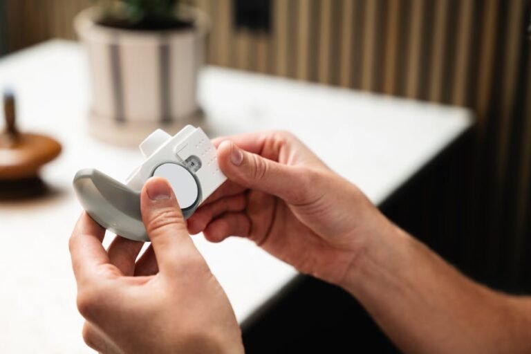 Close-up of hands holding an asthma inhaler, indoors in a modern setting.